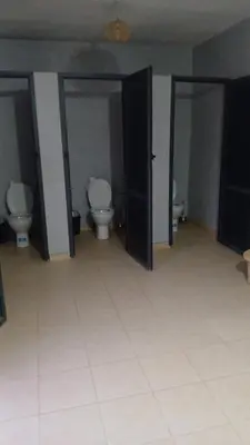 a bathroom with two toilets and two open doors at Merzouga Sunshine traditional luxury camp in Merzouga