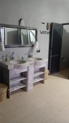 a bathroom with two sinks and a large mirror at Merzouga Sunshine traditional luxury camp in Merzouga