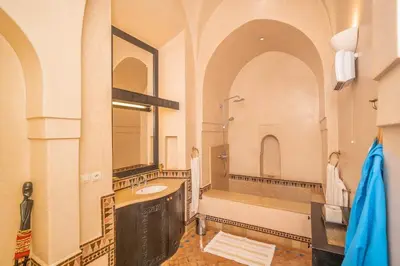 a large bathroom with a sink and a mirror at Beautiful Boccara villa, 4 suites and private pool in Chaibate