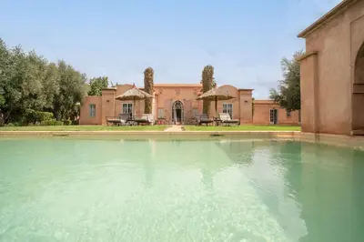 a large pool of water in front of a building at Beautiful Boccara villa, 4 suites and private pool in Chaibate