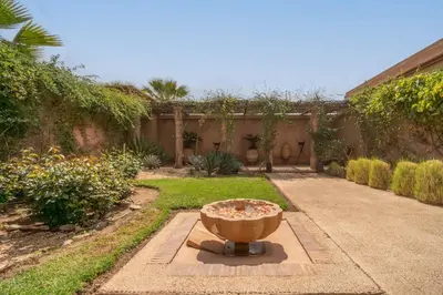 a garden with a bowl in the middle of a yard at Beautiful Boccara villa, 4 suites and private pool in Chaibate