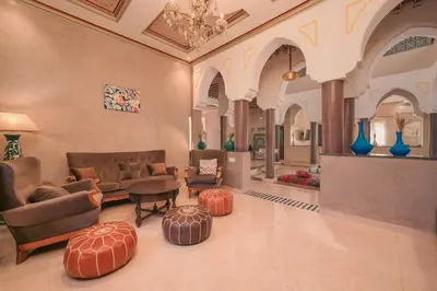 a living room with couches and a table and chairs at Villa Memories 5bedrooms Space, laughter, relaxation in Marrakesh in Douar bel Rhanodour