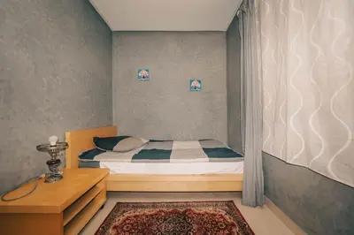 a small bedroom with a bed and a table at Villa Memories 5bedrooms Space, laughter, relaxation in Marrakesh in Douar bel Rhanodour