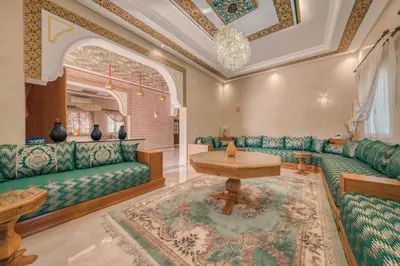 a living room with green couches and a table at Villa Memories 5bedrooms Space, laughter, relaxation in Marrakesh in Douar bel Rhanodour