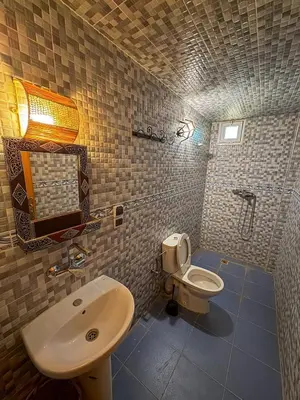 a small bathroom with a sink and a toilet at luxury desert house merzouga 3BR 2 terraces in Merzouga