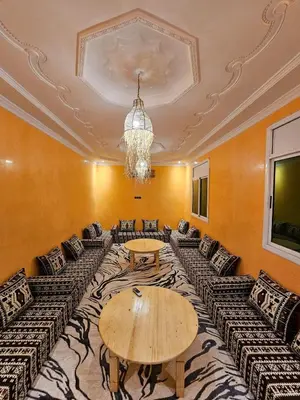 a room with couches and a table and a chandelier at luxury desert house merzouga 3BR 2 terraces in Merzouga