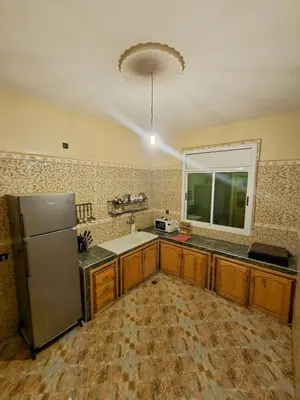 a kitchen with a stainless steel refrigerator and a window at luxury desert house merzouga 3BR 2 terraces in Merzouga