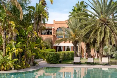 a resort with palm trees and a swimming pool at Dar Basma - Boutique Hotel & Spa by Babakoul Collections in Aït Namous