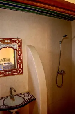 a bathroom with a sink and a mirror at Rimal Travel Camp in Mhamid