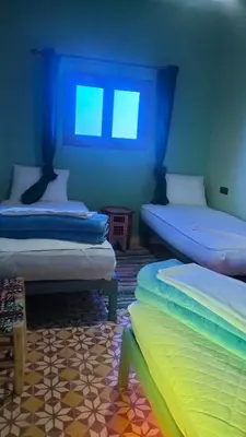 a room with two beds and a window at KasbatTaslit in Ouarzazate