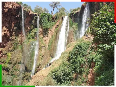 a waterfall on the side of a mountain at Cozy Apartment Near Ouzoud Waterfalls in Azilal