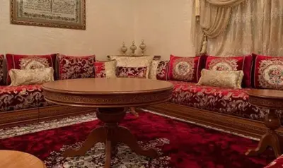 a living room with a couch and a table at Cozy Erfoud apartment - Moroccan charm & comfort in Erfoud