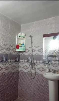 a bathroom with a sink and a mirror at Cozy Erfoud apartment - Moroccan charm & comfort in Erfoud