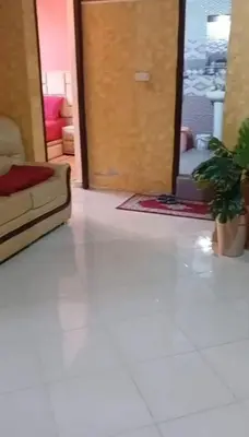 a living room with a couch and a door at Cozy Erfoud apartment - Moroccan charm & comfort in Erfoud