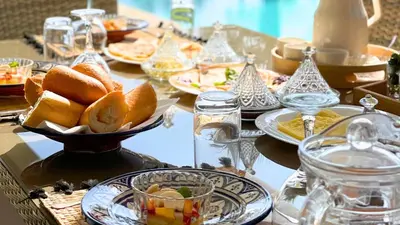 a table with plates of food on a table at Villa Ambre in Marrakech