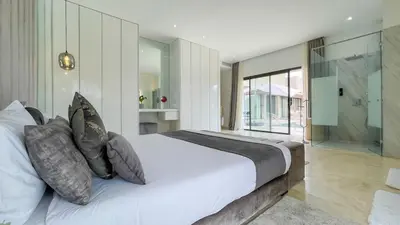 a bedroom with a large white bed with pillows at Villa Ambre in Marrakech