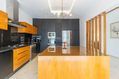 a kitchen with a large wooden island in the middle at Villa Ambre in Marrakech