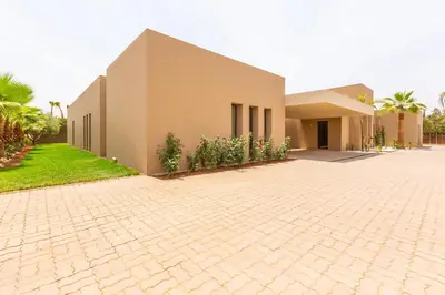 a house with a brick driveway in front of it at Villa Ambre in Marrakech
