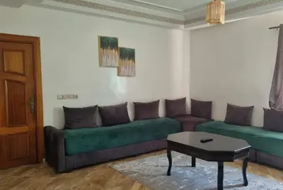 a living room with a couch and a table at Luxurious Accessible Apartment in the Heart of Fes in Fès