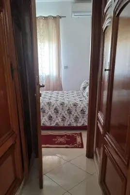 an open door to a bedroom with a bed at Luxurious Accessible Apartment in the Heart of Fes in Fès