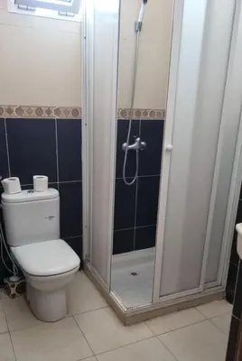 a bathroom with a toilet and a shower at Luxurious Accessible Apartment in the Heart of Fes in Fès