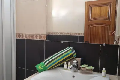 a bathroom with a sink and a mirror at Luxurious Accessible Apartment in the Heart of Fes in Fès