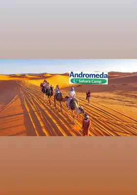 a group of people riding horses in the desert at Andromeda Sahara Camp in Merzouga