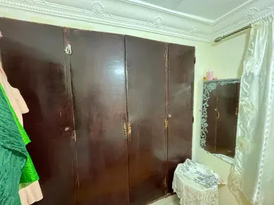 a brown cabinet in a room with a mirror at House medina in Fès