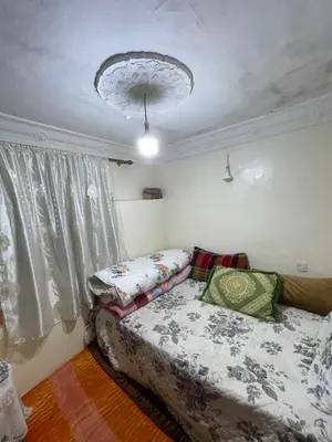a bedroom with a bed and a chandelier at House medina in Fès