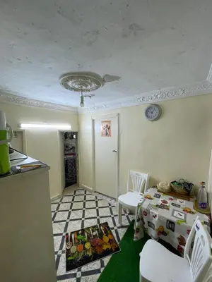 a room with a bed and a table and chairs at House medina in Fès