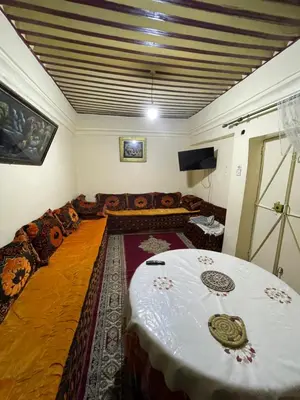 a living room with a table and a couch at House medina in Fès