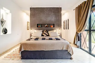 a bedroom with a large bed and a large window at Villa Tamara luxury villa private pool Marrakech in Najem