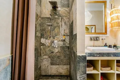 a bathroom with a stone shower and a sink at Villa Tamara luxury villa private pool Marrakech in Najem
