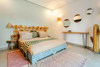 a bedroom with a bed with a large wooden headboard at Villa Tamara luxury villa private pool Marrakech in Najem
