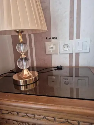 a lamp sitting on top of a glass table at Maison intelligente, idéale pour les familles avec Netflix, parking et ascenseur in Fès