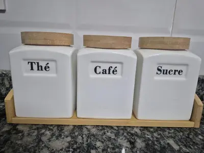 three white containers sitting on a wooden shelf at Maison intelligente, idéale pour les familles avec Netflix, parking et ascenseur in Fès