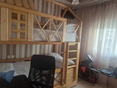 a bedroom with two bunk beds and a chair at Maison intelligente, idéale pour les familles avec Netflix, parking et ascenseur in Fès