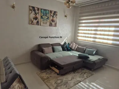 a living room with a couch and a couch and a table at Maison intelligente, idéale pour les familles avec Netflix, parking et ascenseur in Fès