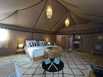 a bedroom with a bed in a tent at Sahara Spirit Luxury Camp in Merdani