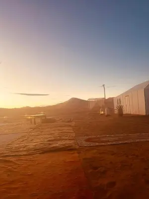 a view of a desert with a building and a field at Sahara Spirit Luxury Camp in Merdani