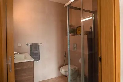 a bathroom with a toilet and a glass shower at Appartement de luxe avec piscine - Agadir Bay in Oulad Akkou
