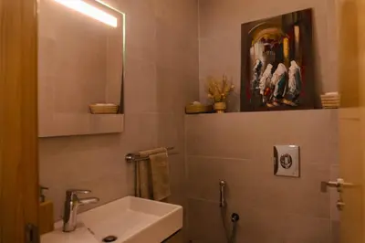 a bathroom with a sink and a mirror at Appartement de luxe avec piscine - Agadir Bay in Oulad Akkou