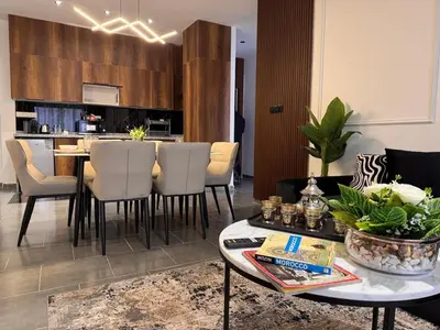 a kitchen and living room with a table and chairs at PAUSE HOUSE-Downtown-Front of Station-Airport Bus-FREE COUSCOUS Friday in Fès