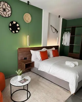 a bedroom with a bed and a table in it at PAUSE HOUSE-Downtown-Front of Station-Airport Bus-FREE COUSCOUS Friday in Fès