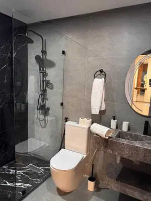 a bathroom with a shower and a toilet and a sink at PAUSE HOUSE-Downtown-Front of Station-Airport Bus-FREE COUSCOUS Friday in Fès
