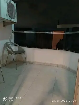 a chair sitting in a room with a window at إقامة حسن in Fès