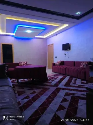 a living room with couches and a blue light at إقامة حسن in Fès
