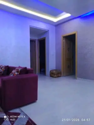a living room with a purple couch in a room at إقامة حسن in Fès