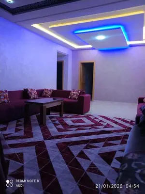 a living room with a couch and a table at إقامة حسن in Fès