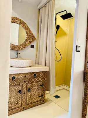 a bathroom with a sink and a mirror at Brilliant luxury camp in Merzouga